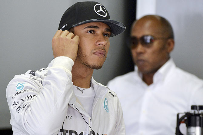 Mercedes Formula One driver Lewis Hamilton (left) stands on the box next to his father Anthony during the qualifying session of the Brazilian F1 Grand Prix at Interlagos circuit in Sao Paulo on Saturday