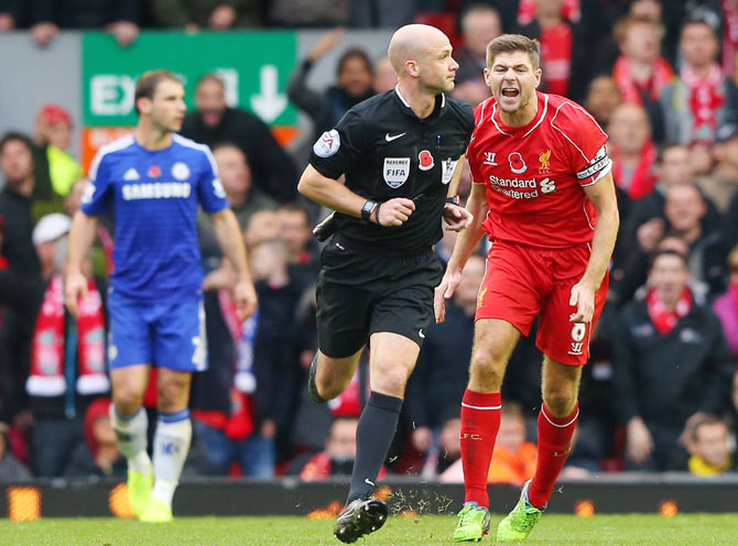 Steven Gerrard of Liverpool appeals to referee Anthony Taylor for a handball during the Premier League match against Chelsea on Saturday