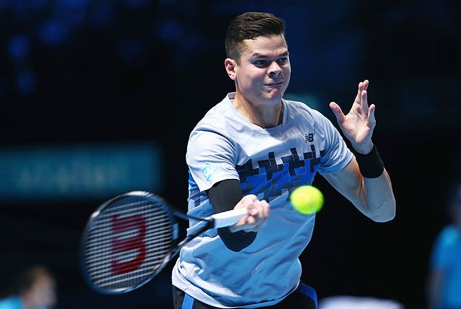 Milos Raonic of Canada plays a forehand against Roger Federer of Switzerland on Sunday