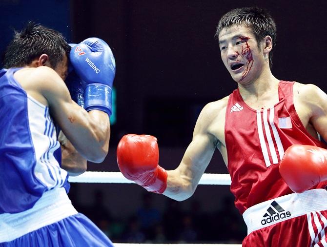 Otgondalai Dorjnyambuu of Mongolia (red) fights Charly Suarez of Philippines