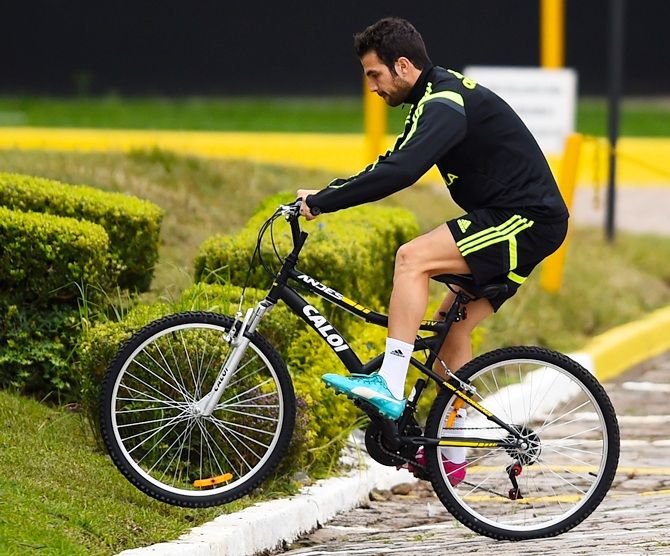 Cesc Fabregas of Spain rides a bicycle 