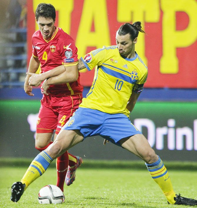 Sweden's Zlatan Ibrahimovic (right) fights for the ball with Montenegro's Nikola Vukcevic during their Euro 2016 Group G qualifying match in Podgorica on Saturday