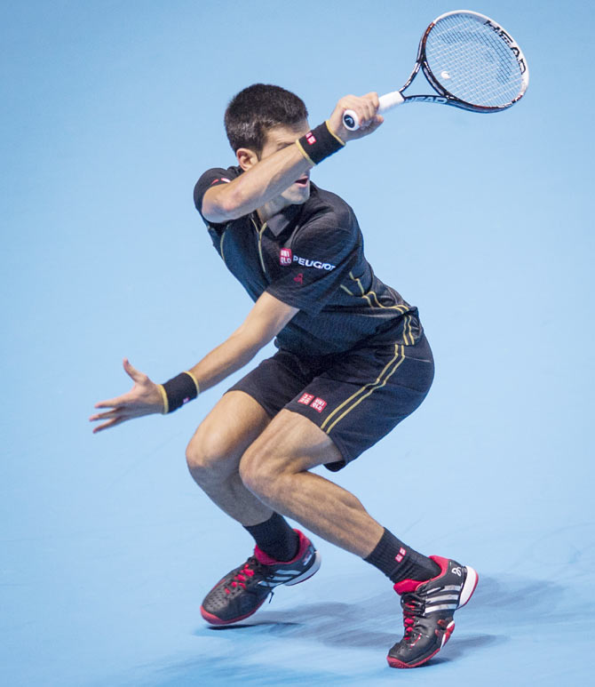 Novak Djokovic of Serbia in action against Marin Cilic of Croatia in their round robin match during the Barclays ATP World Tour Finals