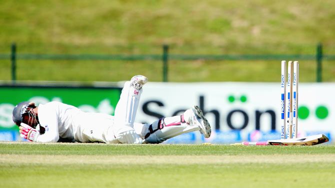 Ahmed Shehzad of Pakistan lies injured after being hit by a bouncer by Corey Anderson of New Zealand on Day 2 of the first Test at Sheikh Zayed stadium in Abu Dhabi, United Arab Emirates on November 10