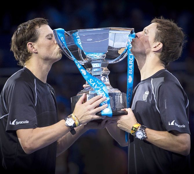 Bob Bryan and Mike Bryan of the United States lift the ATP Doubles Trophy