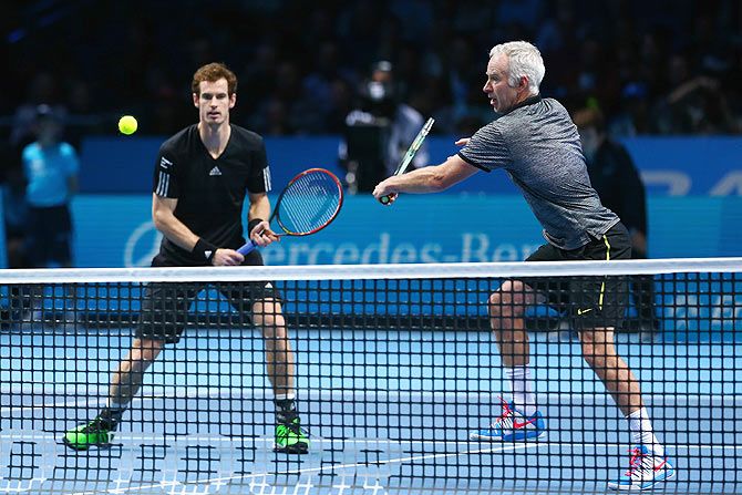 Andy Murray of Great Britain and John McEnroe of USA in action in the exhibition match against Tim Henman of England and Pat Cash of Australia of USA on day eight of the ATP World Tour Finals at O2 Arena on Sunday. The singles final was replaced with an exhibition match after Roger Federer of Switzerland pulled out with an injury