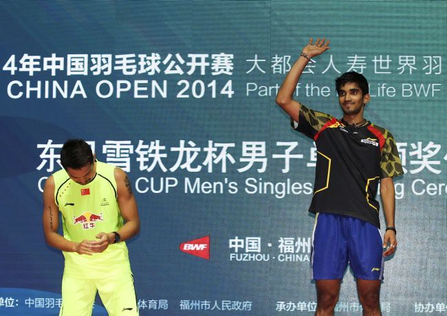 India's Kidambi Srikanth waves on the podium after beating China's Lin Dan