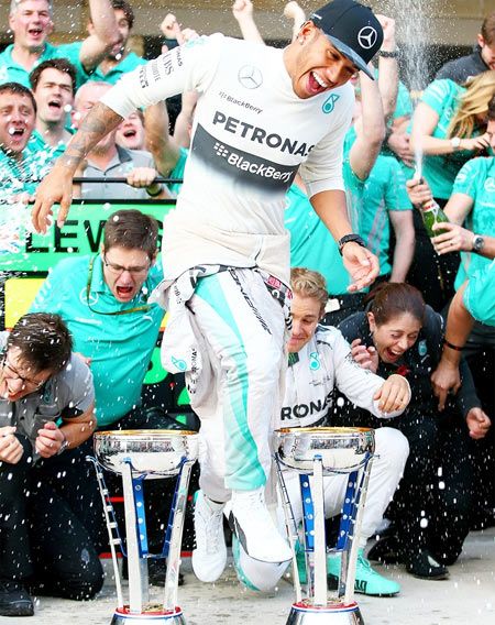 Lewis Hamilton of Great Britain and Mercedes GP celebrates his victory with his team after the United States Formula One Grand Prix
