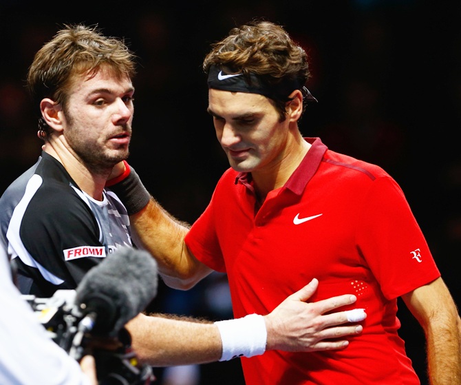  Roger Federer of Switzerland hugs Stanislas Wawrinka