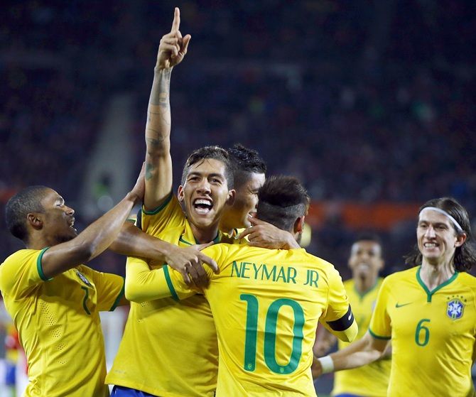 Brazil's Roberto Firmino, centre, celebrates his goal 