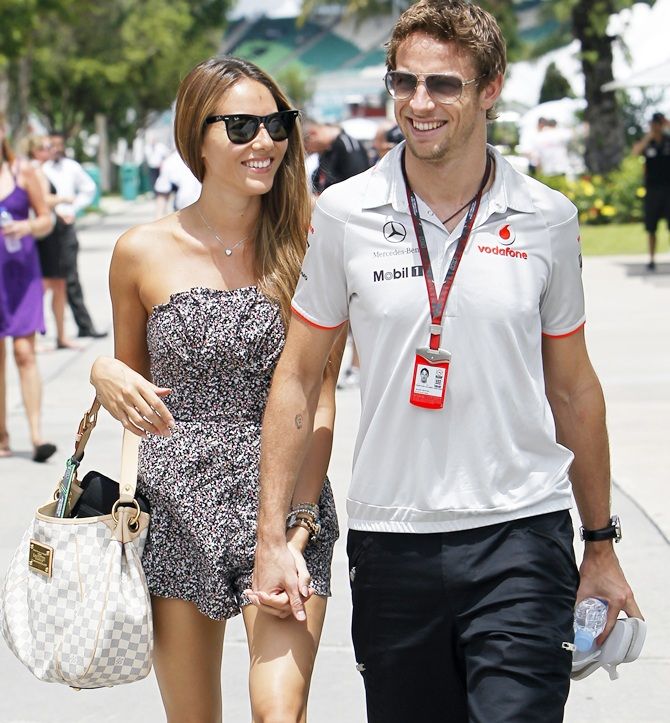 McLaren Formula One driver Jenson Button of Britain and his girlfriend Jessica Michibata