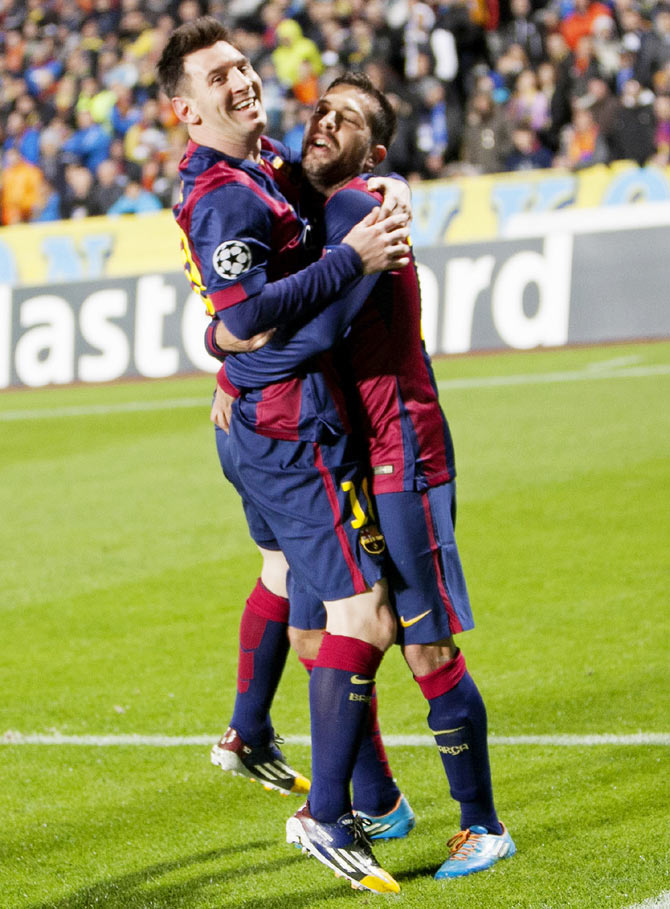 Barcelona's Lionel Messi (left) celebrates after scoring against APOEL Nicosia during their Champions League Group F soccer match at GSP Stadium in Nicosia on Tuesday