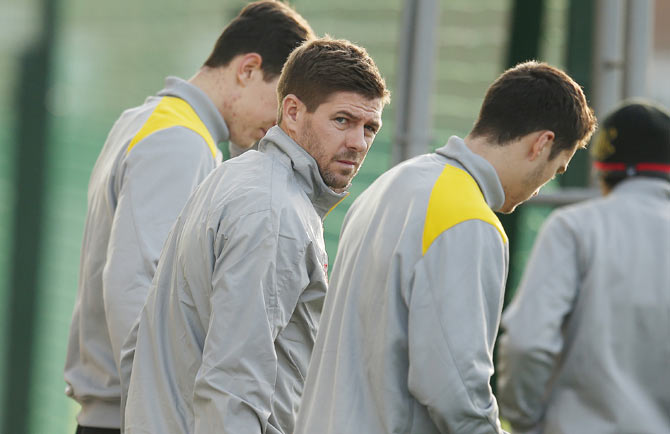 Liverpool's Steven Gerrard (centre) arrives for a training session at the club's Melwood training complex in Liverpool on Tuesday