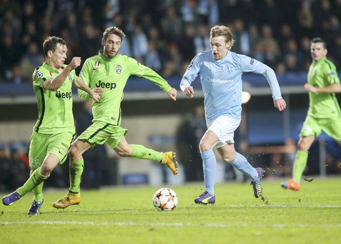 Malmo's Emil Forsberg (2nd from) runs past Juventus' Stephan Lichtsteiner (left) and Claudio Marchisio during their Champions League Group A match on Wednesday