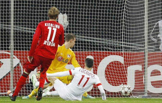 Monaco's Lucas Ocampos (right) scores a goal against Bayer Leverkusen's goalkeeper Bernd Leno (centre) during their Champions League group C match in Leverkusen on Wednesday