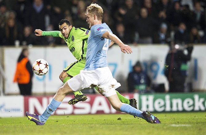 Juventus' Carlos Tevez scores past Malmo's Filip Helander (front) during their Champions League Group A match on Wednesday.