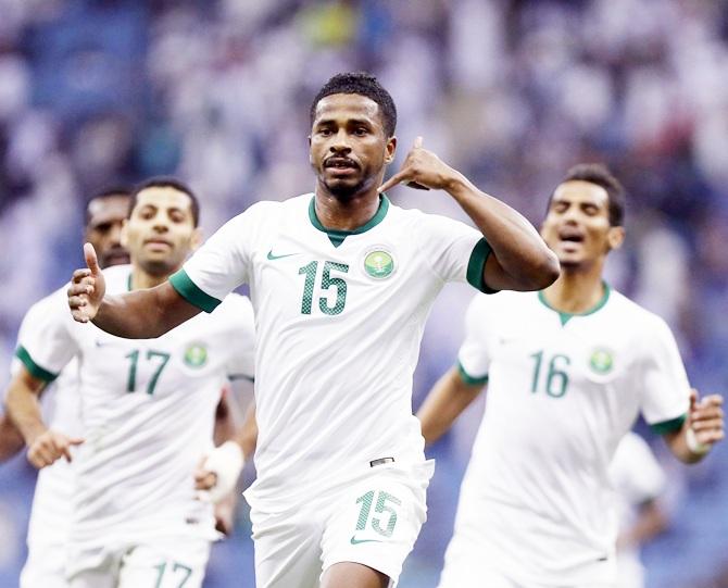 Nasser Al-Shamrani of Saudi Arabia, centre, celebrates