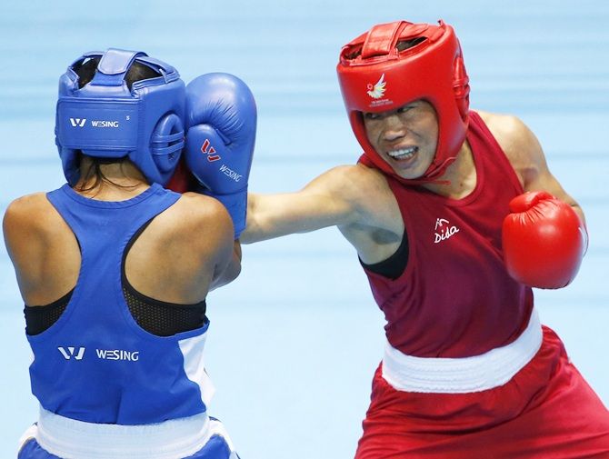 IMAGE: India's M C Mary Kom (red) throws a punch