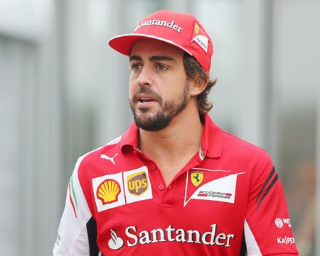 Fernando Alonso of Spain and Ferrari walks across the paddock ahead of the Japanese Formula One Grand Prix at Suzuka Circuit in Japan on Thursday