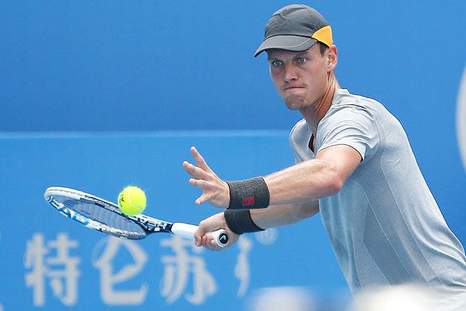   Tomas Berdych of the Czech Republic returns a shot against Viktor Troicki of Serbia 