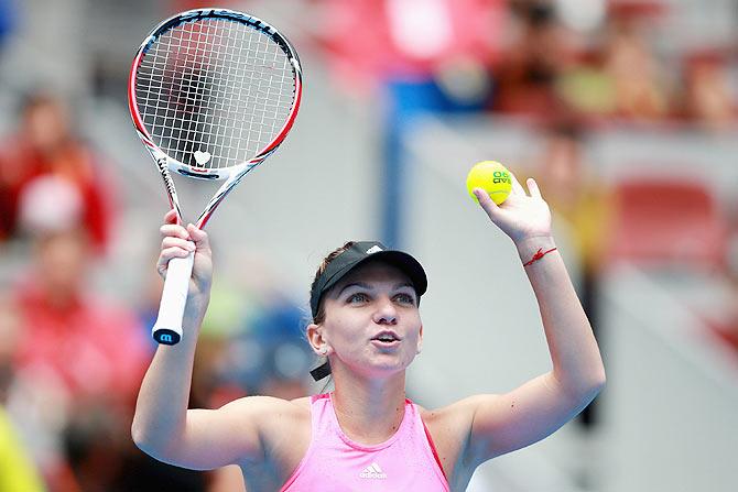 Simona Halep of Romania celebrates winning against Andrea Petkovic of Germany