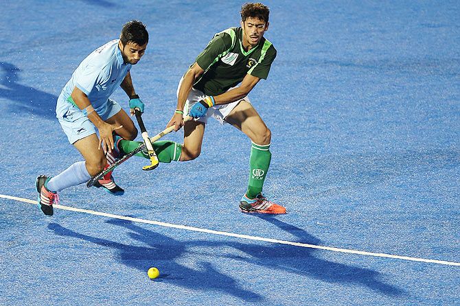 Manpreet Singh of India (left) and a Pakistani player in action during their match on Thursday