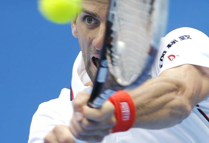 Novak Djokovic of Serbia returns the ball during his men's quarter-final match against Grigor Dimitrov of Bulgaria at the China Open tennis tournament in Beijing on Friday