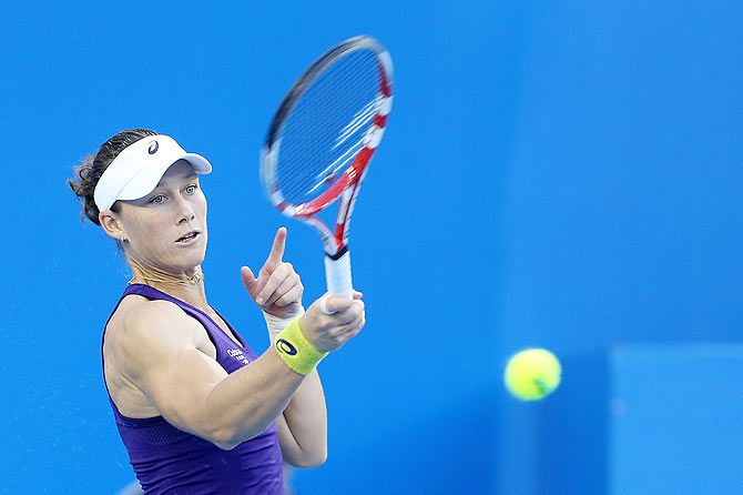 Samantha Stosur of Australia returns a shot against Alize Cornet of France during day six of the China Open