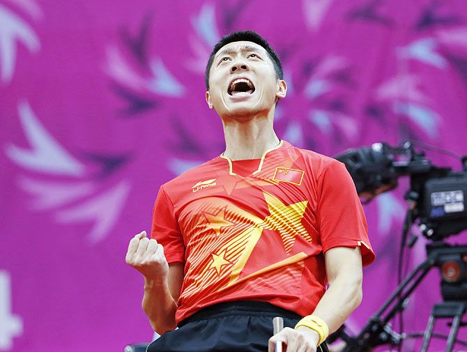 China's Xu Xin reacts after winning a point against his compatriot Fan Zhendong at the men's final table tennis match at Suwon Gymnasium
