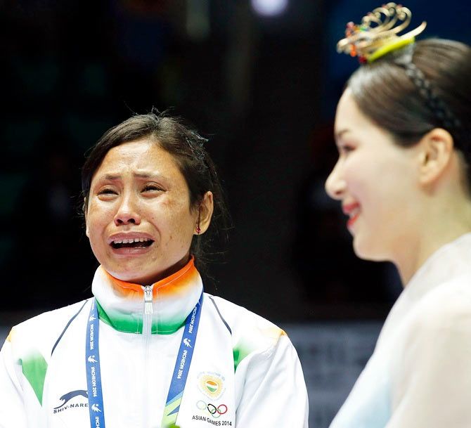  India's bronze medallist Laishram Sarita Devi reacts during the medal ceremony of the women's lightweight (57-60kg) boxing