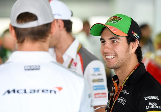 Sergio Perez of Mexico and Force India speaks with Jenson Button