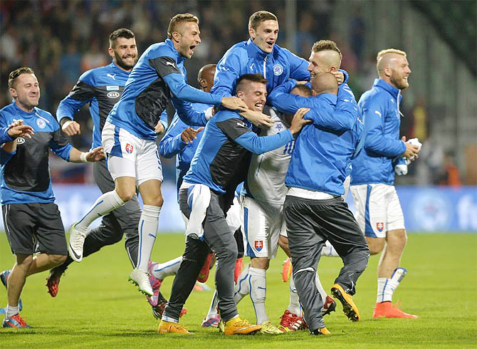 Players of the Slovia football team celebrate after their win over Spain on Thursday