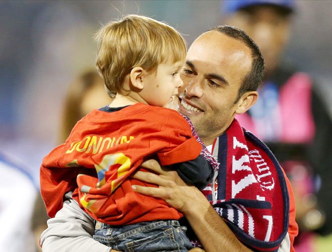 Landon Donovan shares a quiet moment with his son after his final international match of his career on Friday