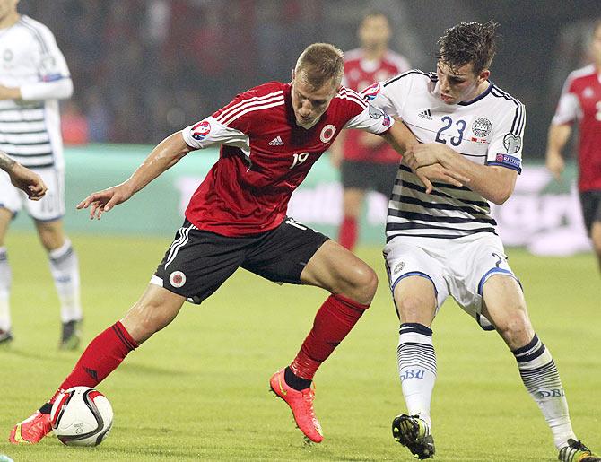 Albania's Bekim Balaj (left) and Denmark's Pierre Hijbjerg fight for the ball during their Euro 2016 qualifying match at Elbasan arena stadium in Elbasan on Saturday