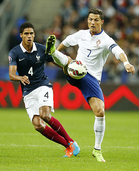France's Raphael Varane (left) challenges Portugal's Cristiano Ronaldo (right) during their friendly match at the Stade de France in Saint-Denis near Paris, on Saturday