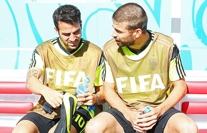 Cesc Fabregas (L) and Gerard Pique of Spain