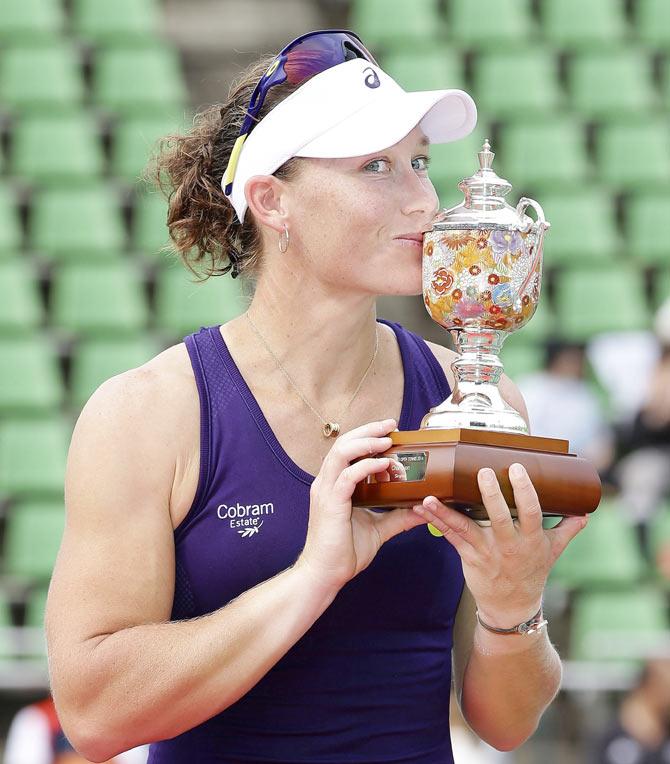 Australia's Samantha Stosur kisses her winner's trophy during an awarding ceremony for women's single at Japan Open women's tennis tournament in Osaka