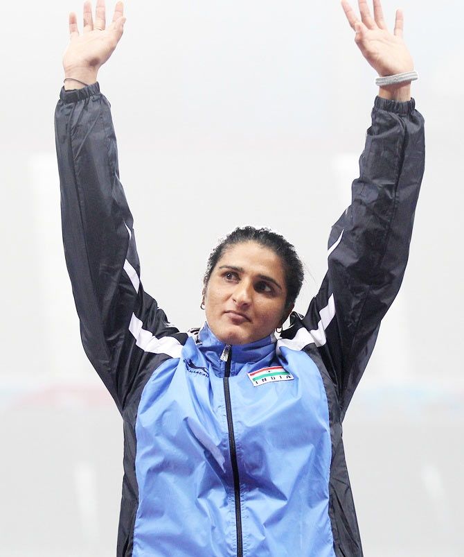 Gold medalist Seema Punia of India celebrates on the podium during the victory ceremony for the Women's Discus Throw of the 2014 Asian Games at Incheon
