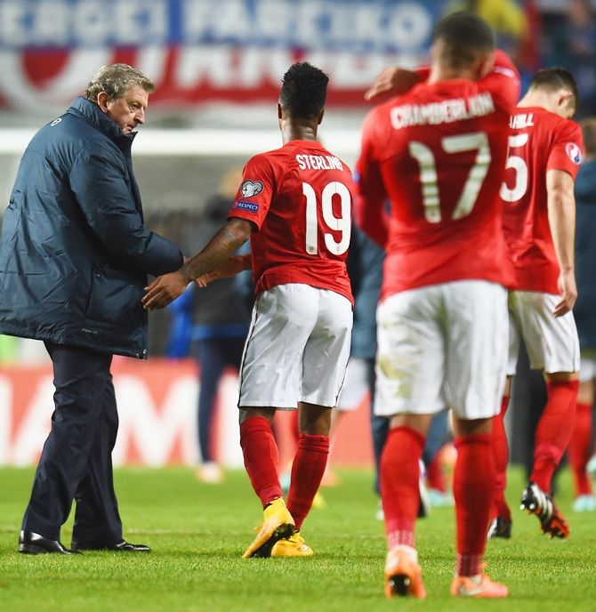  England manager Roy Hodgson shakes hands with Raheem Sterling