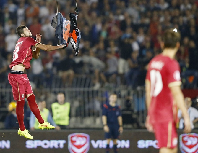 Stefan Mitrovic of Serbia grabs a flag