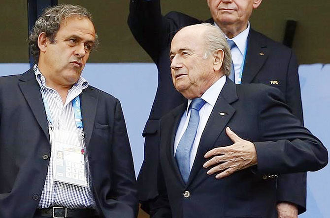 FIFA President Sepp Blatter speaks with UEFA President Michel Platini (left) 