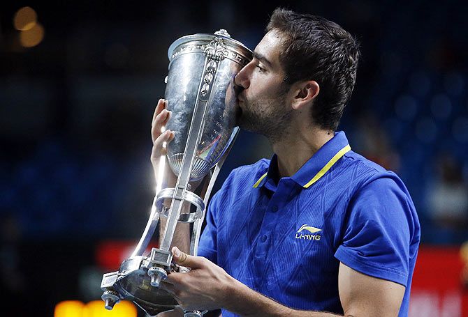 Croatia's Marin Cilic kisses his trophy after defeating Spain's Roberto Bautista-Agut in the men's singles final at the Kremlin cup tennis tournament in Moscow on Sunday