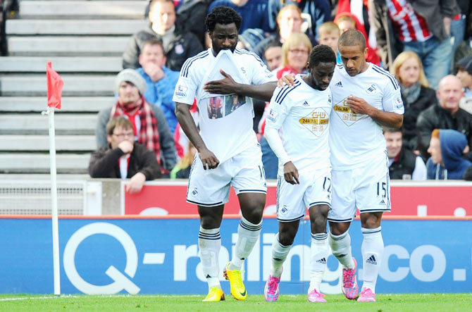 Swansea player Wilfried Bony (left) celebrates after converting a penalty against Stoke City 