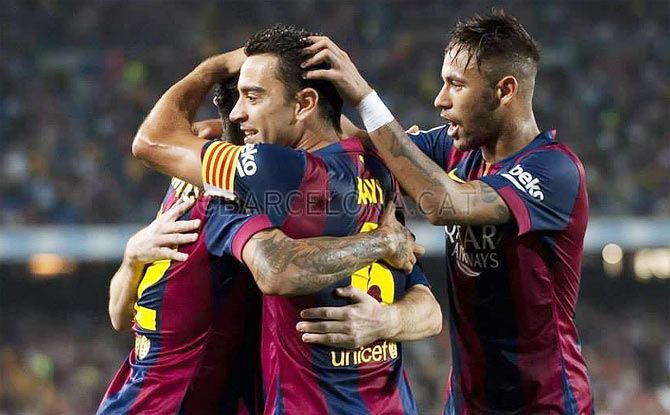 Barcelona's Xavi Hernandez and Neymar celebrate a goal with teammates