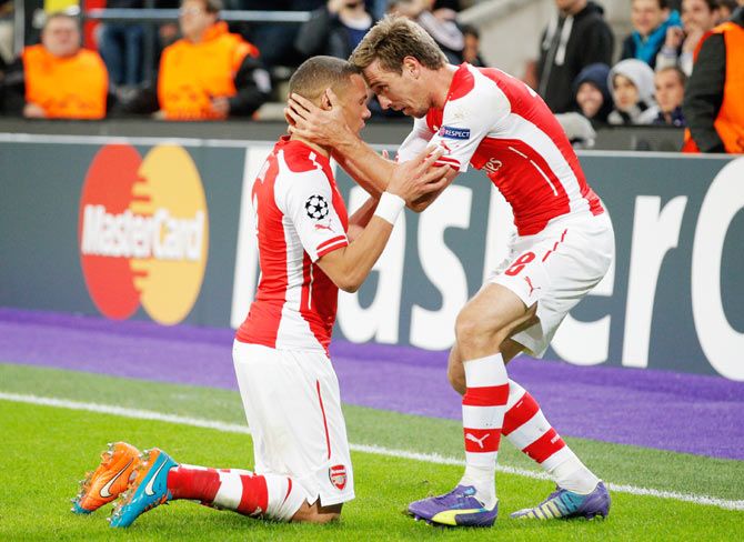 Kieran Gibbs of Arsenal (left) celebrates with teammate Nacho Monreal after scoring against RSC Anderlecht during their UEFA Champions League Group D match at Constant Vanden Stock Stadium in Brussels, Belgium, on Wednesday