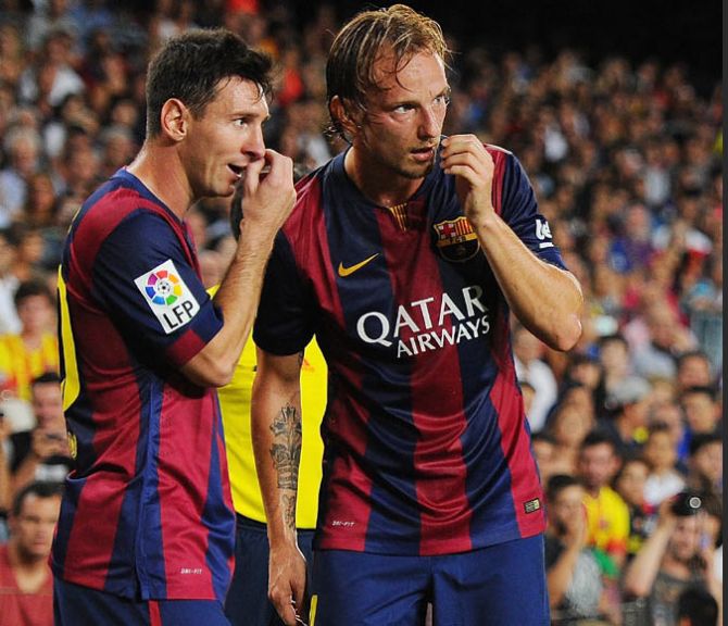 Barcelona's Ivan Rakitic (right) consults with teammate Lionel Messi before taking a freekick 