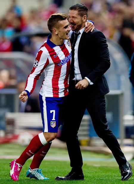 Antoine Griezmann (left) of Atletico de Madrid embraces head coach Diego Pablo Simeone (right) as he celebrates scoring their third goal against Malmo FF during their UEFA Champions League Group A match at Vicente Calderon stadium in Madrid on Wednesday