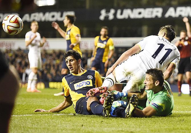 Asteras Tripolis' goalkeeper Tomas Kosicky (right) and teammate Thanasis Pantelladis (left) challenge Tottenham Hotspur's Erik Lamela during their Europa League match at White Hart Lane in London on Thursday