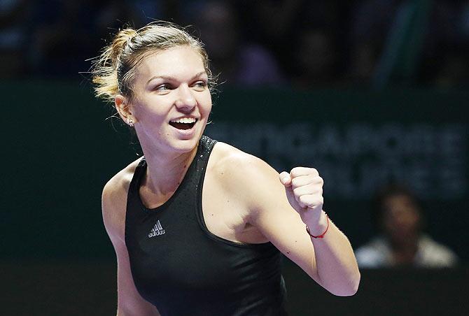 Simona Halep of Romania celebrates her win over Agnieszka Radwanska of Poland during their WTA Finals singles semi-finals match at the Singapore Indoor Stadium on Saturday