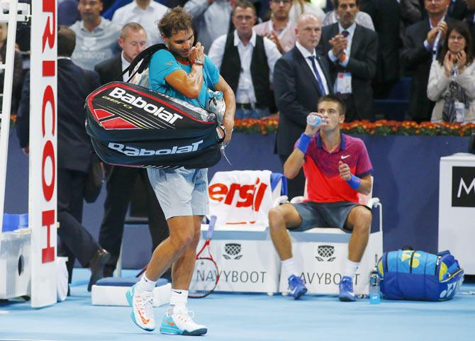 Spain's Rafael Nadal (front left) leaves after losing his match against Borna Coric (right) of Croatia